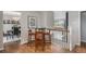 Open-concept dining area with modern table, chairs, hardwood flooring, and easy access to other rooms at 6150 S Southwood Dr, Centennial, CO 80121