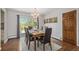 Elegant dining room with stylish furniture, chandelier lighting, and access to outdoor deck at 6150 S Southwood Dr, Centennial, CO 80121