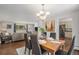 Open concept dining room featuring hardwood floors, chandelier lighting, and connection to living area at 6150 S Southwood Dr, Centennial, CO 80121
