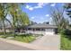 Well-maintained ranch-style home featuring a manicured front yard, inviting porch, and attached garage at 6150 S Southwood Dr, Centennial, CO 80121