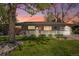 Charming ranch-style home with lush front lawn, red door, and inviting porch at sunset at 6150 S Southwood Dr, Centennial, CO 80121