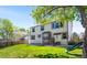Expansive backyard with a well-maintained lawn, patio area, slide, and mature trees for shade at 19817 E Prentice Ave, Centennial, CO 80015