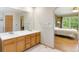 Bathroom with double sink vanity and bedroom access at 19817 E Prentice Ave, Centennial, CO 80015