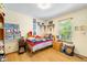 Bright bedroom with a window, light wood floors, and decoratively adorned walls at 19817 E Prentice Ave, Centennial, CO 80015