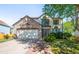 Charming two-story home with a stone facade, attached garage, and manicured lawn at 19817 E Prentice Ave, Centennial, CO 80015