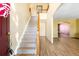 Inviting foyer featuring wood floors, staircase, and access to the dining room for easy entertaining at 19817 E Prentice Ave, Centennial, CO 80015