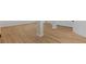 Partially finished basement with a concrete columns, wood floors, and white trim at 41 Eagle Dr, Littleton, CO 80123