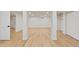 Spacious basement with wood floors, neutral walls, columns, and several doorways at 41 Eagle Dr, Littleton, CO 80123
