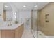 Modern bathroom featuring double vanity, quartz counters, and glass enclosed shower at 41 Eagle Dr, Littleton, CO 80123