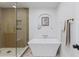 Luxurious bathroom featuring walk-in shower and a freestanding soaking tub at 41 Eagle Dr, Littleton, CO 80123