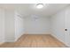 Bright, empty bedroom features neutral paint, wood floors and closet doors at 41 Eagle Dr, Littleton, CO 80123