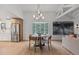 Open floor plan dining room featuring vaulted ceilings, bay window and access to kitchen at 41 Eagle Dr, Littleton, CO 80123