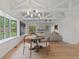 Bright dining area with vaulted ceilings, bay windows, and a view to the living room at 41 Eagle Dr, Littleton, CO 80123