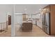 Modern kitchen featuring an island with seating, stainless steel appliances, and a stylish backsplash at 41 Eagle Dr, Littleton, CO 80123