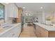 Well-designed kitchen with white cabinets, stainless steel appliances, and easy access to the dining area at 41 Eagle Dr, Littleton, CO 80123