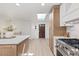 Bright, open kitchen featuring light wood floors, a skylight, and modern stainless steel appliances at 41 Eagle Dr, Littleton, CO 80123