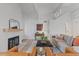 Inviting living room with vaulted ceilings, exposed beams, and a cozy fireplace at 41 Eagle Dr, Littleton, CO 80123