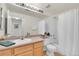 Simple bathroom with shower/tub combo and wood cabinets at 1113 S Alton St # A, Denver, CO 80247