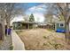 Backyard featuring patio, wooden fence, shed, and landscaping, creating a private outdoor space at 1945 Yosemite St, Denver, CO 80220
