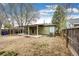 Expansive backyard featuring a covered patio, providing an ideal outdoor living and entertainment space at 1945 Yosemite St, Denver, CO 80220