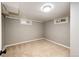 Finished basement corner featuring neutral paint, new carpet, and small windows for natural light at 1945 Yosemite St, Denver, CO 80220
