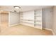 View of the Basement featuring neutral walls, carpeted floor, and a large built-in shelving unit at 1945 Yosemite St, Denver, CO 80220