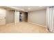 Finished basement offers new carpet, neutral paint, utility access, and sliding barn door at 1945 Yosemite St, Denver, CO 80220