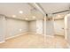 Finished basement featuring new carpet, neutral paint, recessed lighting, and access to utilities at 1945 Yosemite St, Denver, CO 80220