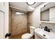 This bathroom has a tiled shower, toilet, and vanity with modern fixtures and a clean, minimalist design at 1945 Yosemite St, Denver, CO 80220