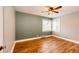 A bright bedroom features hardwood floors, a ceiling fan, and large windows providing ample natural light at 1945 Yosemite St, Denver, CO 80220