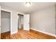 Bedroom featuring hardwood floors, neutral paint, and two doorways leading to other areas at 1945 Yosemite St, Denver, CO 80220