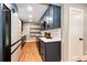 Modern kitchen with stainless steel appliances, dark blue cabinets, and quartz countertops at 1945 Yosemite St, Denver, CO 80220