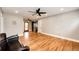 Open-concept living room with hardwood floors, recessed lighting, and seamless flow to the kitchen at 1945 Yosemite St, Denver, CO 80220