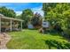 Expansive backyard with covered patio, shed, and ' playset at 7900 E Iowa Ave, Denver, CO 80231