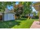 Large, lush backyard with shed, playhouse, mature trees, and plenty of green space at 7900 E Iowa Ave, Denver, CO 80231