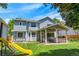 A spacious backyard features a covered patio, lush lawn, and play area at 7900 E Iowa Ave, Denver, CO 80231