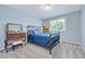 Bright bedroom with large window, carpet, bed, and a dresser at 7900 E Iowa Ave, Denver, CO 80231