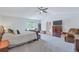 Spacious bedroom featuring a window seat, ceiling fan, and ensuite bathroom entrance at 7900 E Iowa Ave, Denver, CO 80231