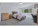 Comfortable bedroom featuring a bed, dresser, and a window at 7900 E Iowa Ave, Denver, CO 80231