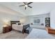 Bright bedroom features vaulted ceilings, a window seat, and neutral carpet at 7900 E Iowa Ave, Denver, CO 80231