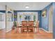 A dining room with wood flooring, natural light, and modern fixtures creating a comfortable and inviting space at 7900 E Iowa Ave, Denver, CO 80231