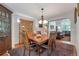Dining room with hardwood floors, a chandelier, and access to the living room at 7900 E Iowa Ave, Denver, CO 80231