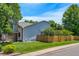 Exterior view of a home with siding, brick accents, a wooden fence, and well-maintained landscaping at 7900 E Iowa Ave, Denver, CO 80231