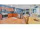 Open kitchen featuring wooden cabinets, stainless steel appliances and granite countertops, seamlessly connected to the living room at 7900 E Iowa Ave, Denver, CO 80231