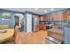 An open view of a Kitchen featuring wooden cabinets, stainless steel appliances and wood flooring at 7900 E Iowa Ave, Denver, CO 80231