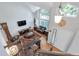 Inviting living room featuring hardwood floors, high ceilings, and large windows providing ample natural light at 7900 E Iowa Ave, Denver, CO 80231
