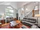 Bright living room features high ceilings, large windows, and hardwood floors at 7900 E Iowa Ave, Denver, CO 80231