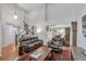Spacious living room with high ceilings, hardwood floors, and a view of the staircase at 7900 E Iowa Ave, Denver, CO 80231
