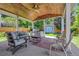 Covered patio with wood ceiling, ceiling fan, and outdoor furniture for relaxing and entertaining at 7900 E Iowa Ave, Denver, CO 80231