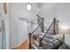 Elegant staircase with wrought iron railings and hardwood steps at 7900 E Iowa Ave, Denver, CO 80231